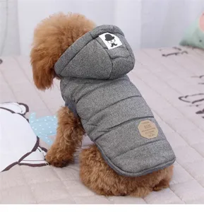 Detailed view of grey quilted pet dog winter hooded vest coat with warm padding and back label.