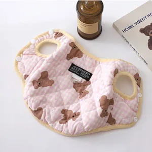 Close-up detail of cute pink plaid pet winter warm vest with cute brown bear pattern.