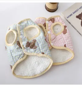 Detailed view of cute fleece-lined pet dog vest with bear print and snap buttons in blue and pink.