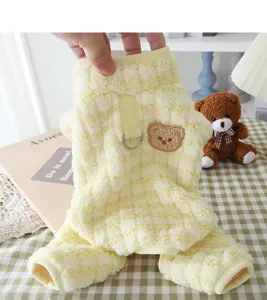 Close-up detail of soft yellow puppy fleece four-legged jumpsuit with cute bear embroidery.