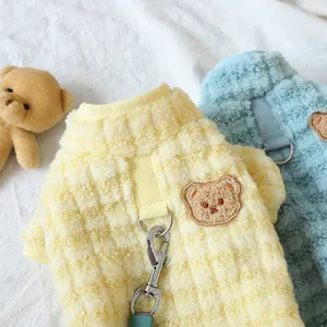 Cute teddy bear embroidery detail on warm fleece pet dog clothes close up shot.