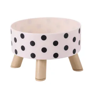 Elevated ceramic pet bowl with black polka dots and wooden stand for cats and dogs