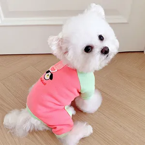 Detail shot of cute pet dog clothes, pink and green color-blocking four-legged home wear.