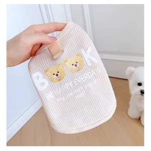 Detail view of a cute pink waffle dog vest with sweet bear graphic and happy text print.