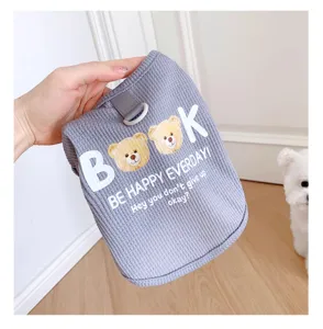 Detailed shot of waffle pet vest with cute bear graphic and English text, soft fabric for small dogs