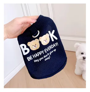 Detailed shot of dark blue waffle pet vest with cute bear print and letter design for small dogs.