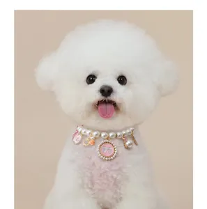 Detailed close-up of a cute pet pearl necklace with pink bow pendant, perfect for small dogs.