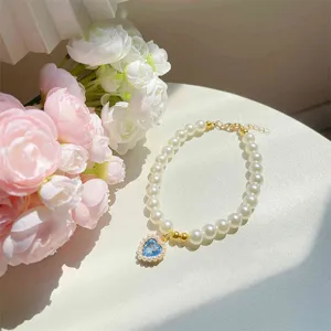 Cute pet pearl necklace with blue heart pendant for cats, elegant princess style collar.