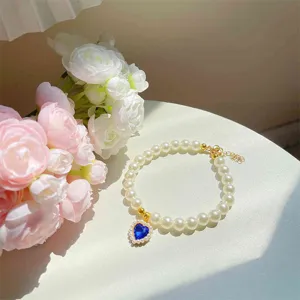 Pet pearl necklace with blue heart crystal pendant, cute cat collar for photo shot.