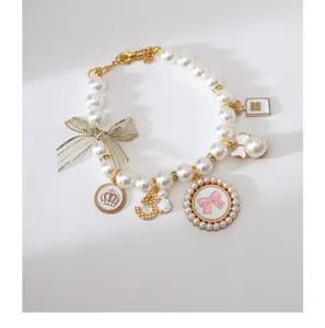Pet pearl necklace detail showing vintage pendant, bowknot, and elegant charms for dogs.