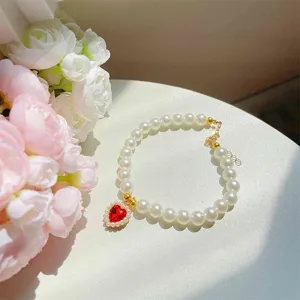 Princess style pet pearl necklace with red heart crystal pendant, perfect for cat photo props.