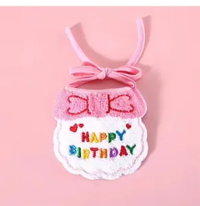Cute pet birthday bib detail showcasing colorful embroidered letters and sweet pink bow design.