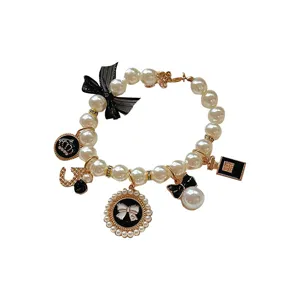 Vintage pet pearl necklace with bows and luxury style charms for small dogs and cats styling.