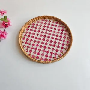 Handwoven rattan tray with pink shell mosaic pattern, round decorative serving fruit tray.