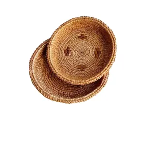 Handmade round woven rattan storage basket fruit tray for home desktop daily use.