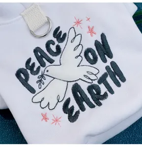 White cat hoodie with peace dove embroidery, cute pet apparel detail presentation.