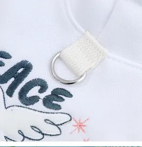 Detailed view of white pet cat hoodie with cute peace dove embroidery and letter print.