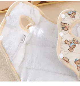 Close-up detail of thickened warm pet cotton vest with cute bear print and soft fleece lining.