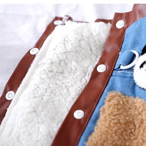 Close-up detail of pet denim cotton coat with fleece lining, leather trim and cute panda pocket.