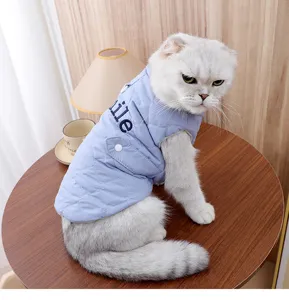Blue quilted pet vest for cats, cute winter warm two-legged clothing with pocket detail.