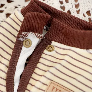 Detail shot of striped pet dog clothes collar with snap buttons and warm winter fabric design.