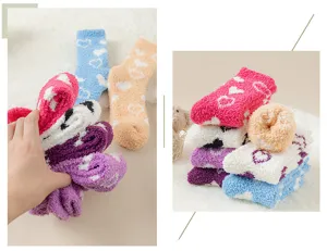 Detailed view of fluffy coral fleece heart pattern fuzzy socks, showing thickness and texture.