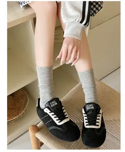Detailed shot of gray ribbed cotton socks paired with casual shoes, soft daily wear style.