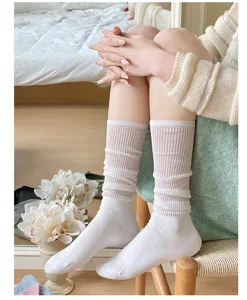 Detail shot of white mesh mid-calf socks, showing sheer hollow-out breathable knit texture.