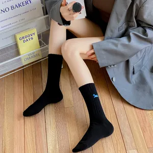 Black mid-calf cotton socks with cute blue embroidery. Breathable and stylish daily wear.