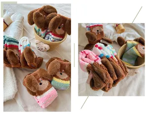 Close-up of thick plush winter socks with cute 3D puppy ears and cozy coral fleece texture.