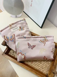Ins style pink butterfly cosmetic bag, large capacity portable makeup pouch and travel organizer.