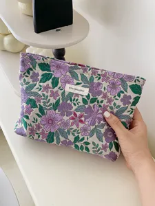 Close-up detail of vintage floral jacquard cosmetic pouch with elegant purple flowers.
