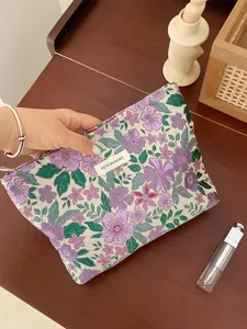 Vintage French jacquard cosmetic bag detail featuring purple floral embroidery and zipper.