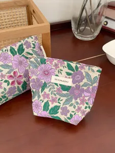 Close-up detail of the vintage French floral jacquard cosmetic bag showing delicate texture.