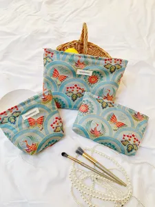 Detailed view of large capacity vintage brocade cosmetic bags featuring crane and butterfly patterns.