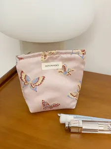 Pink butterfly cosmetic bag for women, cute portable toiletry pouch, large capacity travel storage.