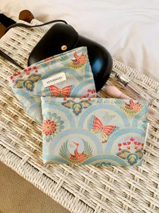 Detail view of the elegant butterfly and crane patterned cosmetic pouch for daily storage.