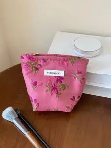 Floral canvas cosmetic pouch detail view, portable makeup storage bag featuring floral pattern.