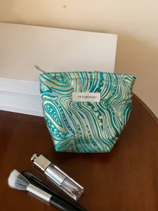 Detail view of the luxury jacquard cosmetic bag, stylish pattern and spacious interior.