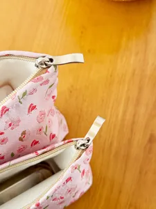 Korean style floral makeup pouch detail shot, cute canvas cosmetic storage bag for women.