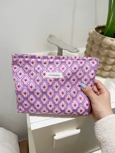 Quilted purple cosmetic bag with charming flower pattern, portable storage pouch for daily use.