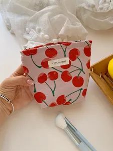 Cherry print canvas cosmetic bag detail view, portable makeup and toiletry storage pouch.