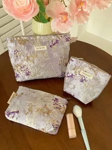 Purple embroidered floral cosmetic bag detail, featuring makeup pouches for travel and storage.