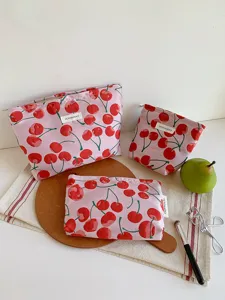 Detail shot of pink cherry jacquard cosmetic bag set, featuring soft fabric and cute design.