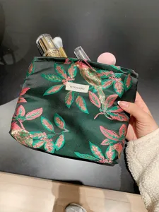 Dark green floral embroidered cosmetic bag, portable makeup pouch with zipper for travel.
