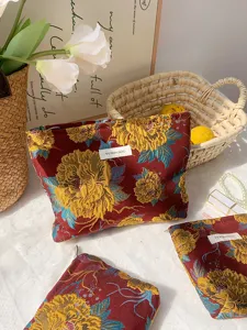 Detail view of vintage floral jacquard cosmetic bag, spacious travel storage organizer.