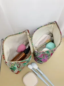 Detailed view of large capacity embroidered floral cosmetic bag interior and zipper layout.