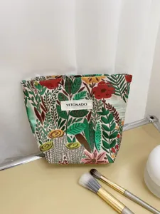 Detailed close-up of the vintage embroidered floral makeup bag showing intricate fabric texture.