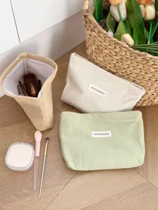Detailed view of large capacity corduroy cosmetic bags in various soft pastel colors.