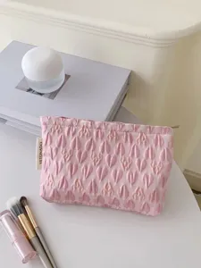 Pink 3d textured cosmetic bag large capacity portable makeup pouch for daily travel use.
